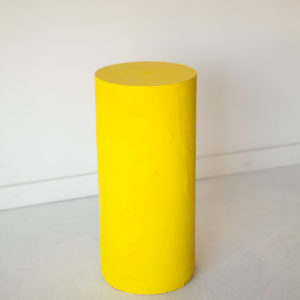 yellow plaster circle pedestal table
