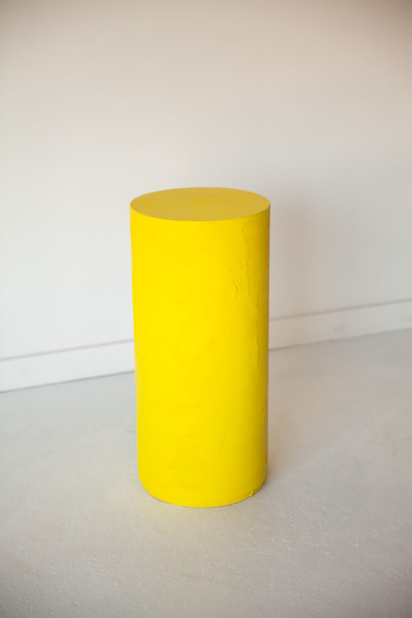 yellow plaster circle pedestal table